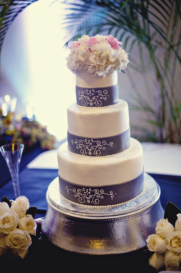 wedding cake with floral topper and purple detail - wedding photo by top Atlanta based wedding photographers Scobey Photography